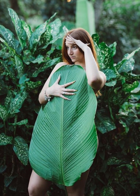 @mikailadancer onlyfans model picture covering her body with leaves