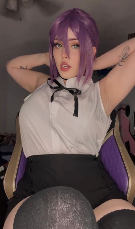 @bunni3png onlyfans model sitting wearing her cosplay costume. Wearing a purple hair