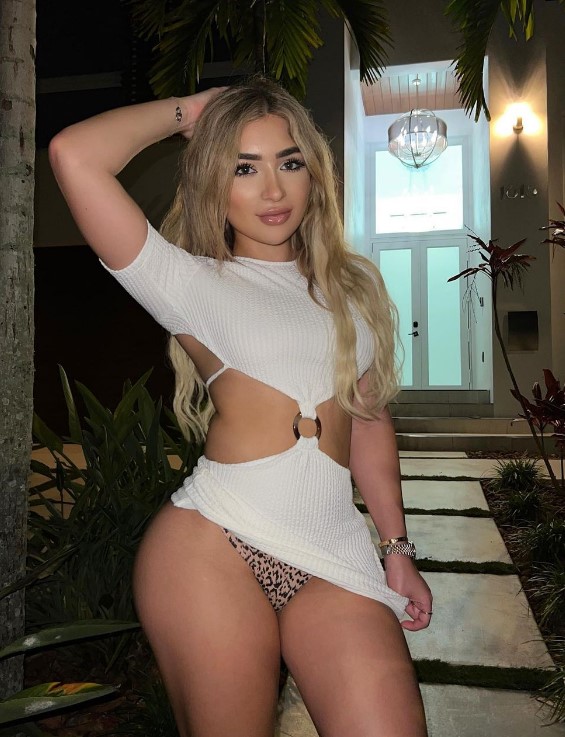 Faith Lianne onlyfans model standing wearing white dress