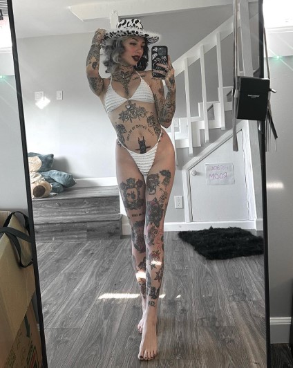 Cruella Morgan onlyfans model ig leaks picture standing wearing a hat and white bikini