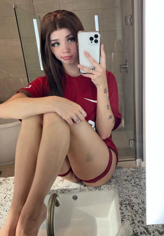 @puppiwi onlyfans model picture wearing red tshirt while sitting on sink