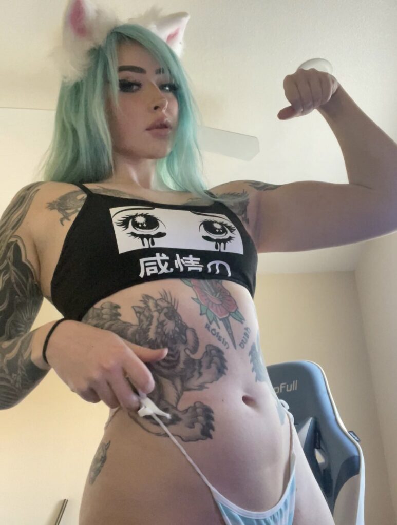 @strongwaifu onlyfans model wearing a black top and blue underwear while flexing muscle