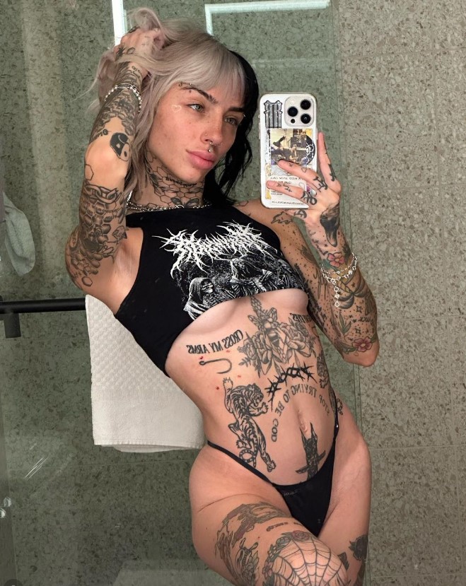 Cruella Morgan onlyfans tattoed model cruella morngan taking a selfie in the bathroom with black lingerie