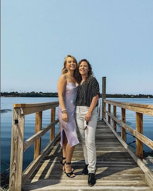 @haileeandkendra onlyfans model couple is standing on a dock and taking a picture