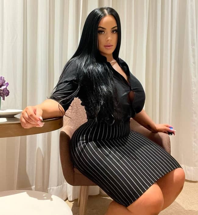 @iamgemstar onlyfans model sitting and wearing black dress