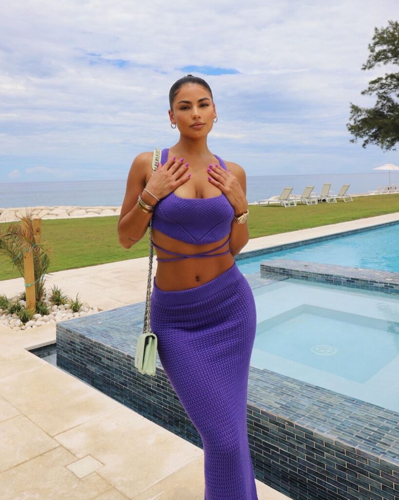 @jaderamey onlyfans model wearing purple dress near the pool