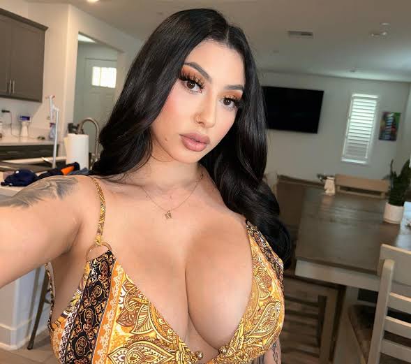 @mariafagredano onlyfans model wearing gold top showing her cleavage