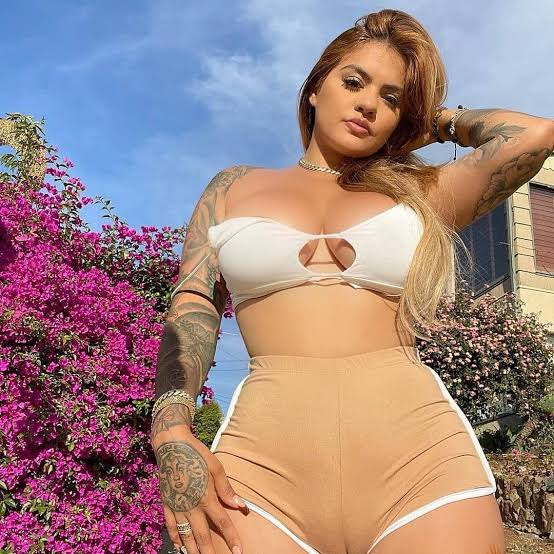 @misstiff onlyfans model is wearing white top and brown shorts