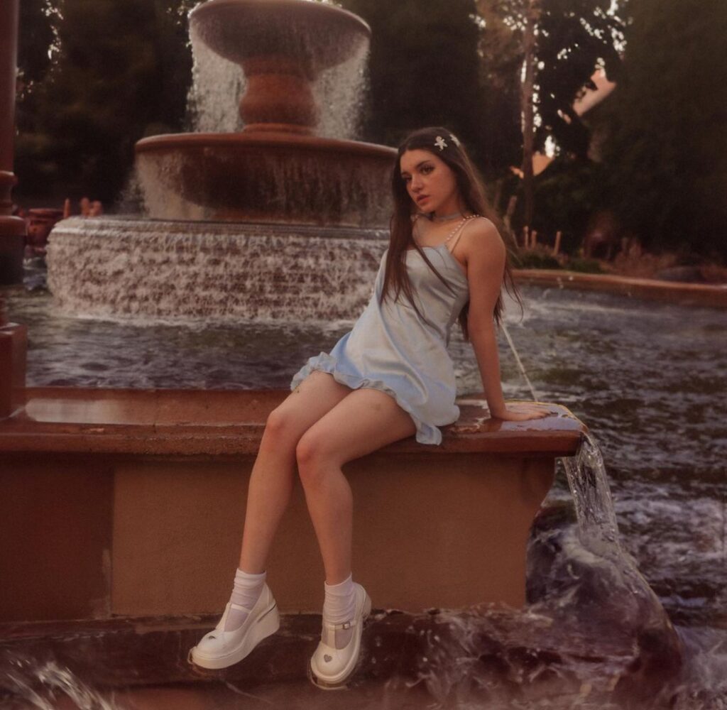 @lilmochidoll onlyfans model sitting on a fountain