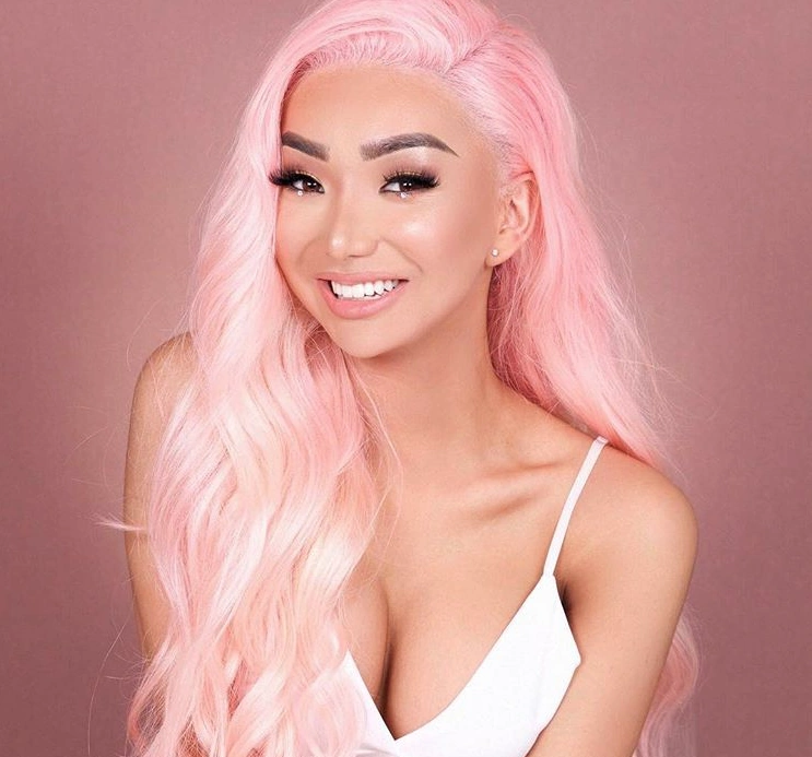 Nikita Nguyen onlyfans model in her pink hair and wearingw white top