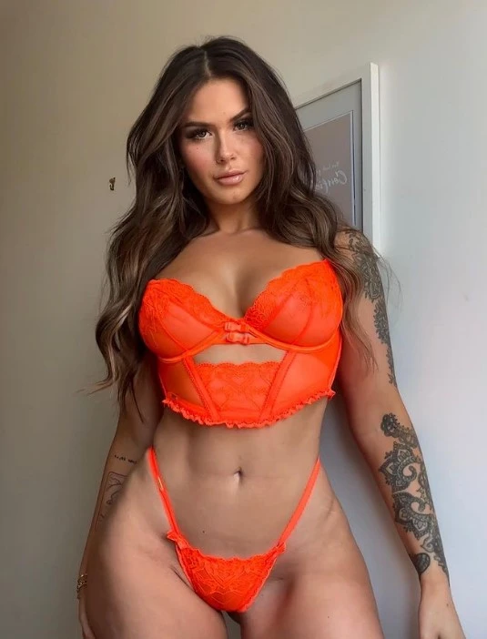 picture of Arabella Mia (@greengirlbella) onlyfans model standing wearing sexy orange lingerie