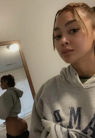 @filipinacolada onlyfans model picture wearing gray jacket and showing her butt