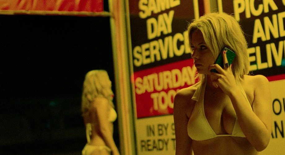 Ashley Benson leaks in the movie Spring Breakers. She standing wearing white bra holding her phone