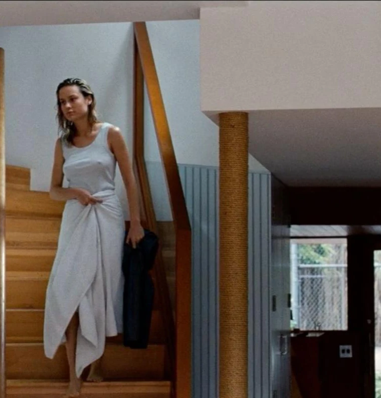 Brie Larson leaks in the movie Digging for Fire. She is going down to stair wearing white top and a towel