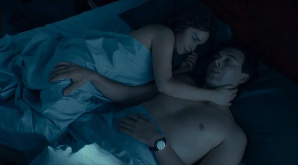 Emilia Clarke leaks in the movie Above Suspicion. She is lying down to bed with a man