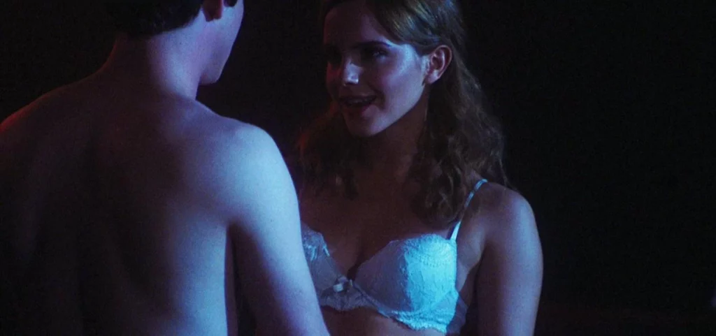 Emma Watson in the movie scene Perks of Being a Wallflower. She is standing wearing a white bra with a man.