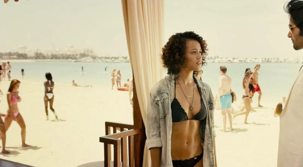 Nathalie Emmanuel leaks in the movie Furious 7. She is standing talking to a man and she is wearing black bra