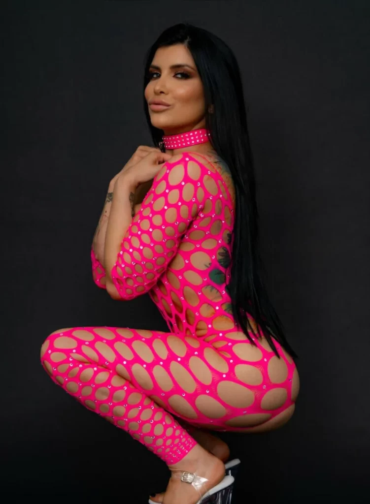 Romi Rain @romi_rain OnlyFans Model sexy photo wearing a pink dress