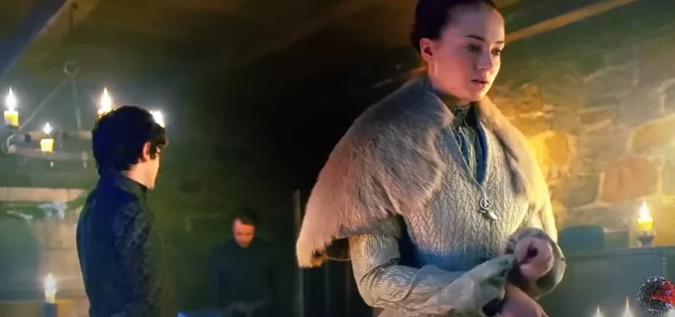 Sophie Turner leaks in the movie Game of Thrones. She is standing in a room with a man