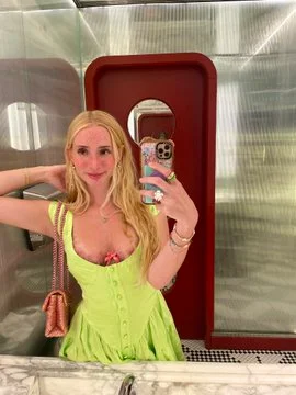 Madison Moore onlyfans model taking a mirror selfie and wearing a green dress
