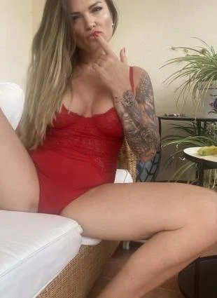 Sarah Montana (@sarahmontanavip) OnlyFans model picture sitting wearing red one piece lingerie