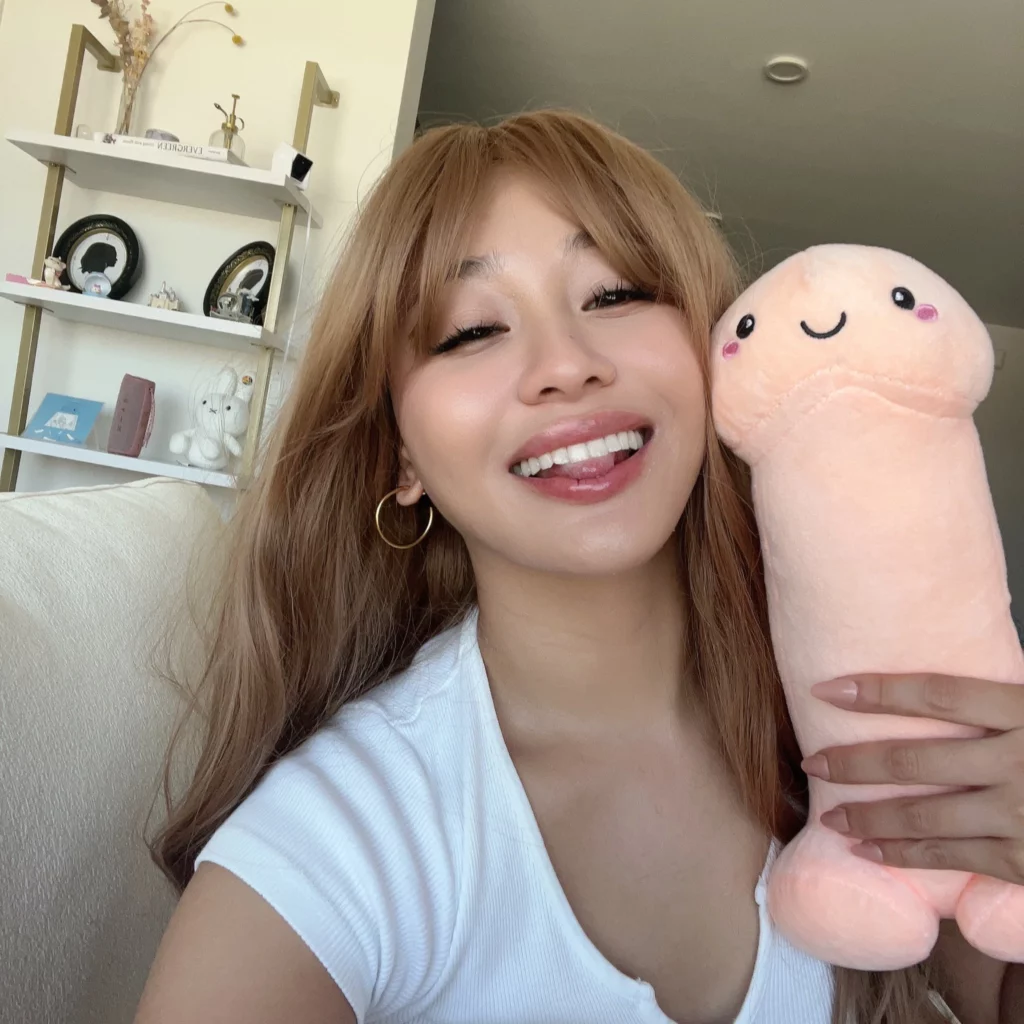 Jasmine Grey (@jasminegrey) OnlyFans model picture holding a dick stuffed toy