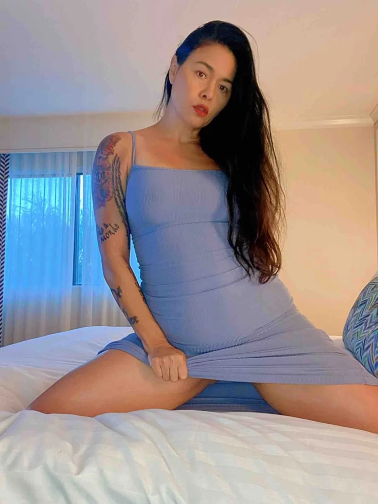 Dana Vespoli (@thedanavespoli) OnlyFans model sexy picture in bed wearing blue dress