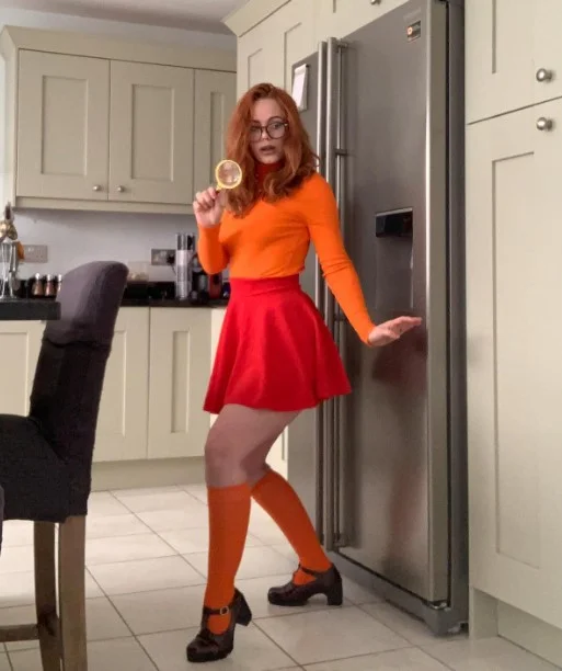 Ella Hughes (@ellahughesxxx) OnlyFans model sexy picture in kitchen wearing orange top