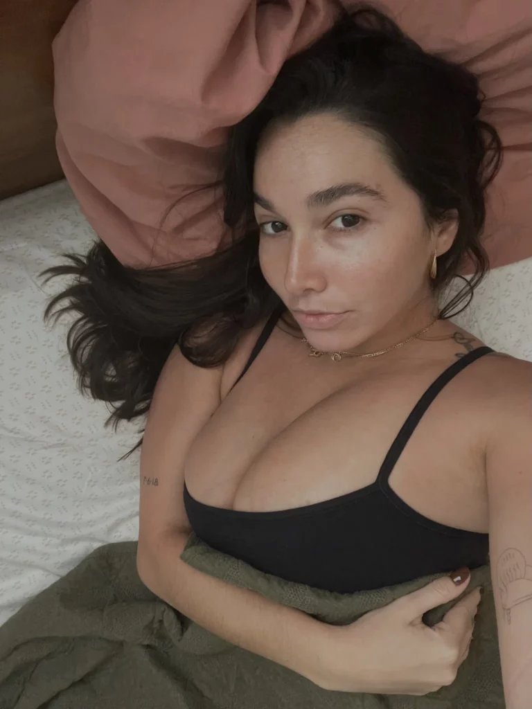 Karlee Grey (@karleegrey) OnlyFans model sexy picture lying down in bed wearing black top