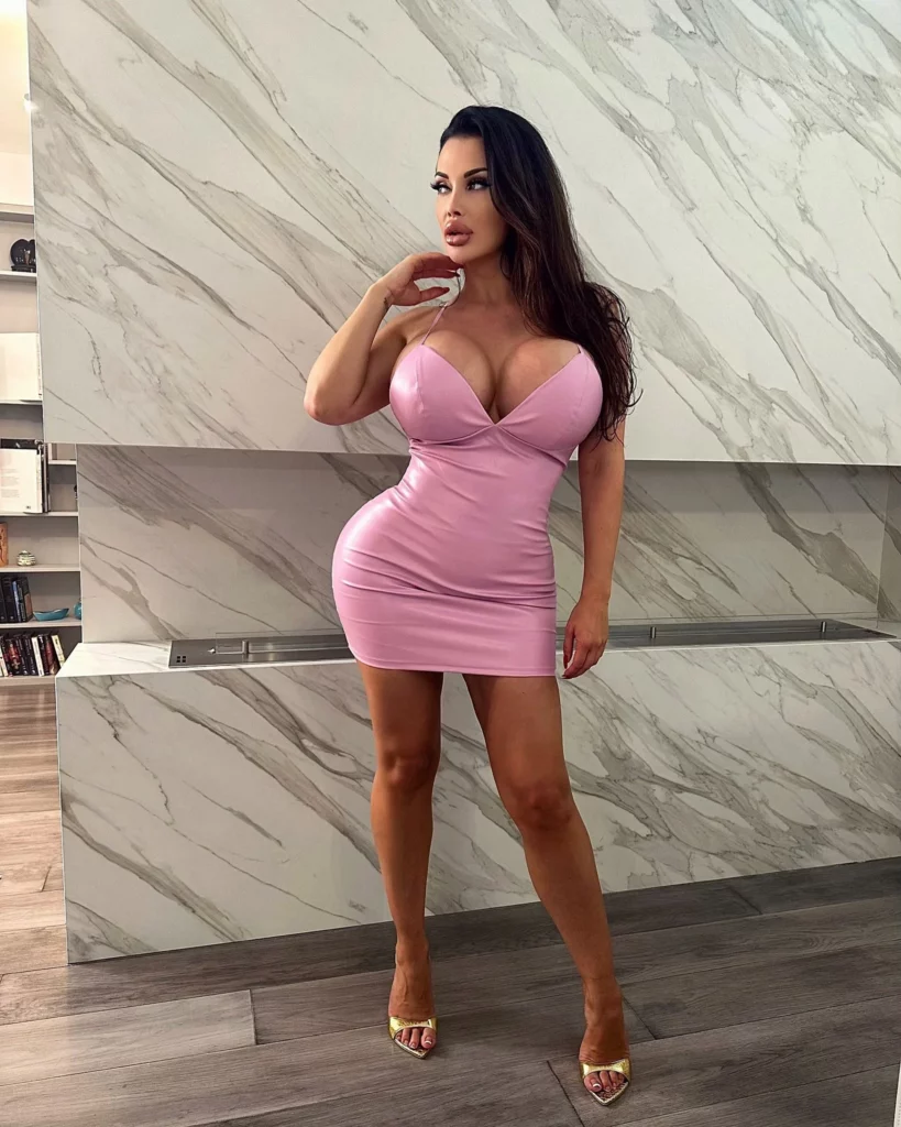 Aletta Ocean (@alettaoceanxxxx) OnlyFans model sexy picture wearing sexy pink fitted dress